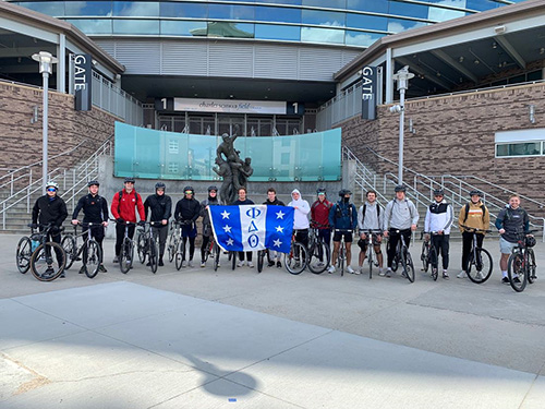 Ethan and frat brothers on bikes.