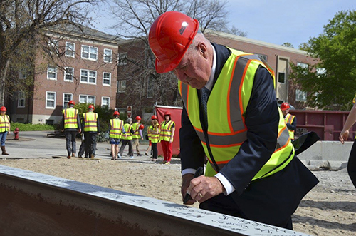 Hawks signing beam during construction of Hawks Hall.