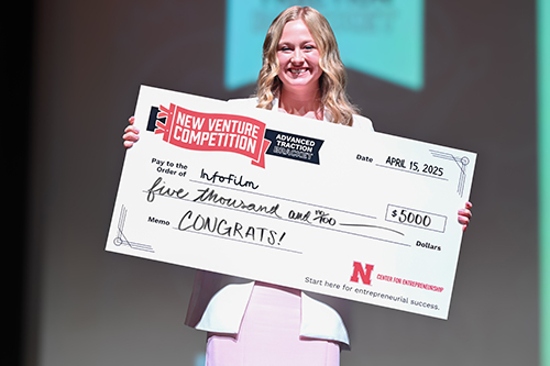Entrepreneur and recent graduate Madison Kreifels, '25, poses with her award at the Nebraska Center for Entrepreneurship's New Venture Competition. 
