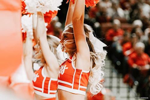 Sydney waving poms at Husker game.