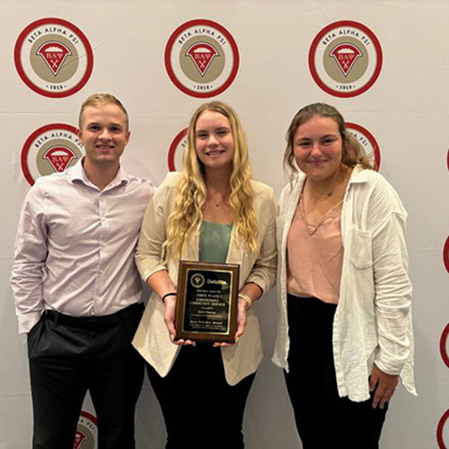 Three students with award