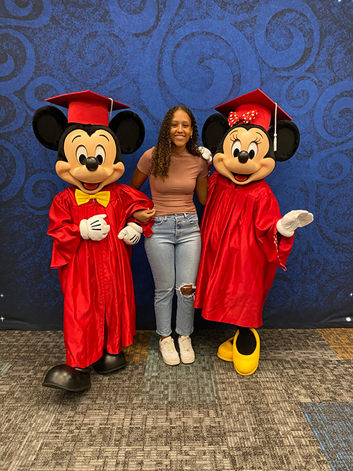 Jada Moore celebrates with Mickey and Minnie Mouse.