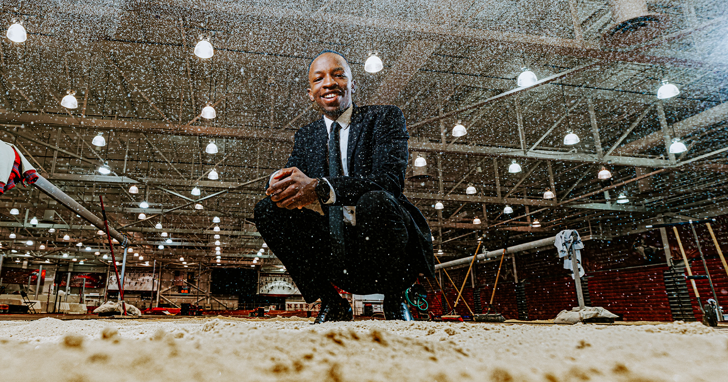 Passmore Mudundulu poses in a track sand pit dressed in a suit.